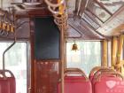 車廂內(nèi)景：紅色仿皮面座椅、木紋扶手、金色鈴鐺